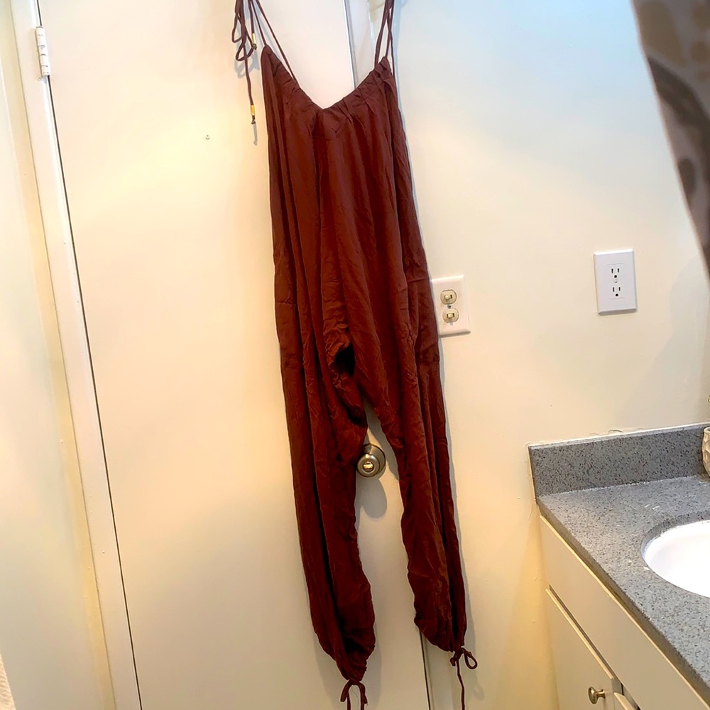 Jumpsuit.Ties at shoulder and bottom.Brand new